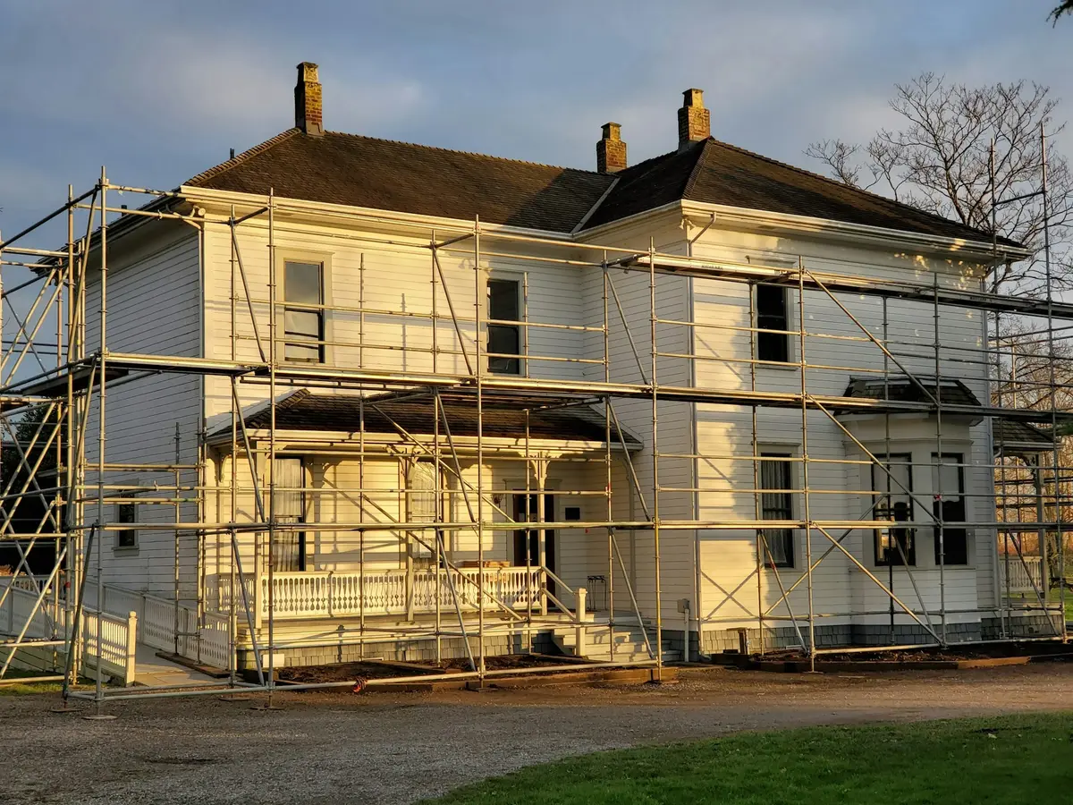 Scaffolding erected around a house to provide roof and exterior access