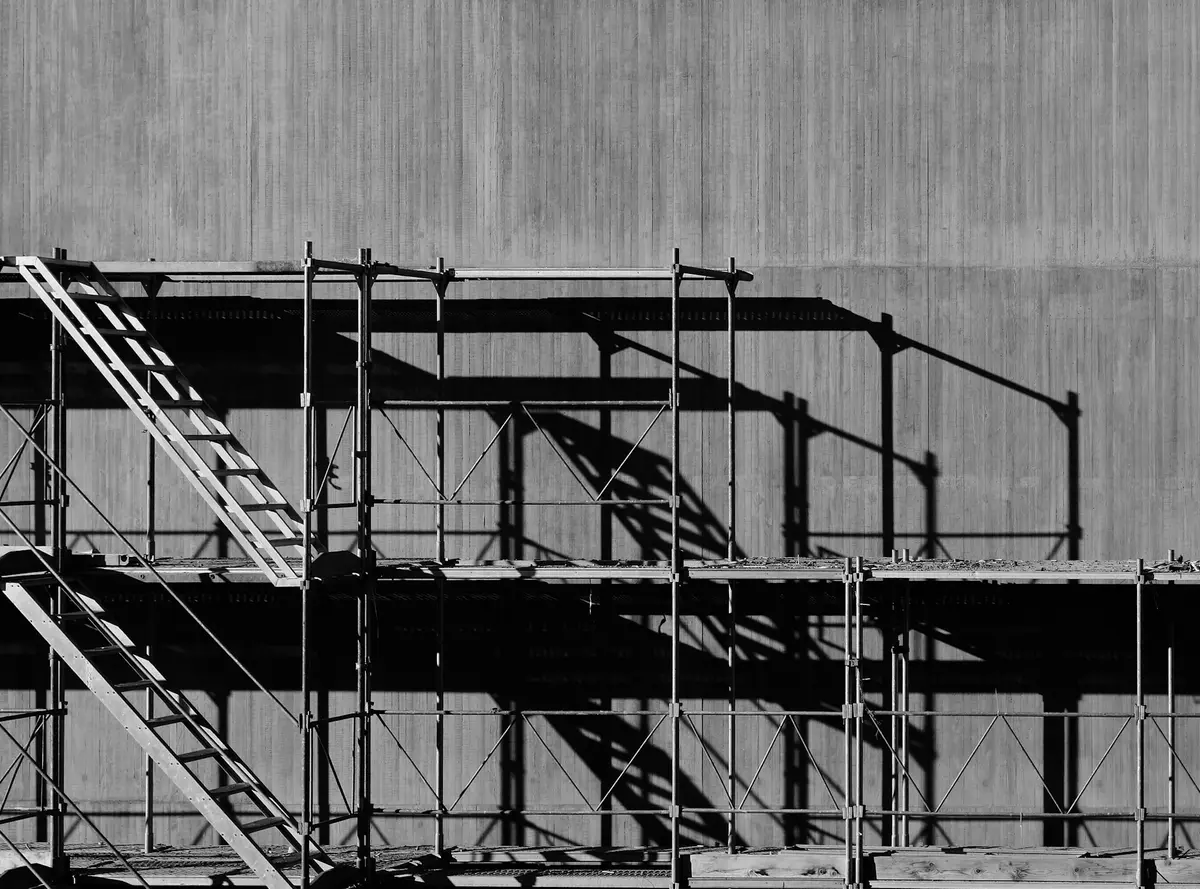 Steel scaffold structure erected against the exterior of a building